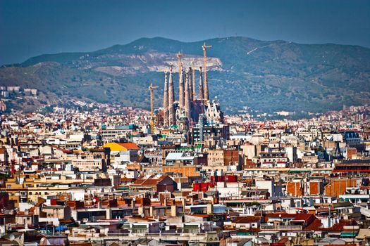 Aerial view of Barcelona, Spain, with the Sagrada Familia towering above the rooftops of the city