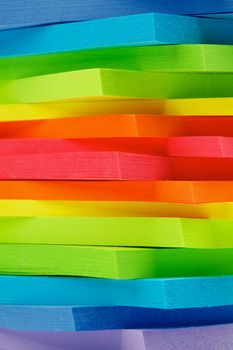 Stack of Rainbow Colored Post It Notes Stickers closeup as Background