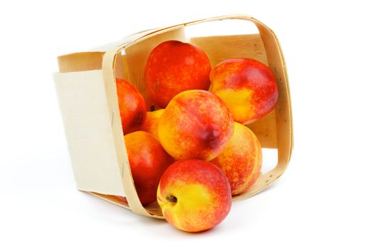 Heap of Perfect Ripe Nectarines Scattered of Basket closeup isolated on white background