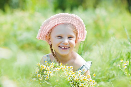 small girl with camomiles