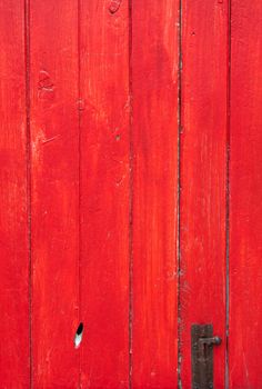 Handmade red painted wooden door with old lock