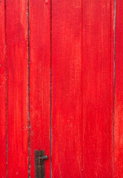 Handmade red painted old wooden door with door lock