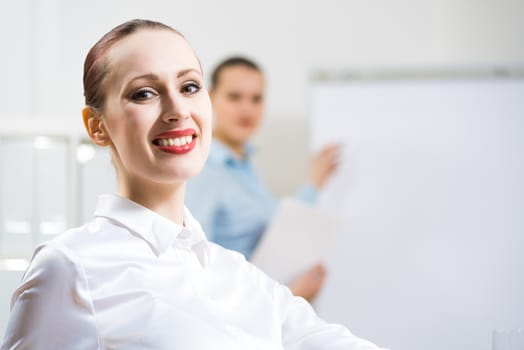 portrait of a business woman in office, smiling and looking into the camera, office work