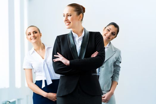 successful business woman in the office, colleagues stare over his shoulder