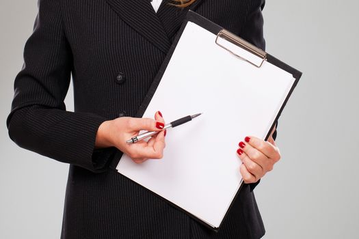 Pen on a blank paper in businesswoman hands with manicure