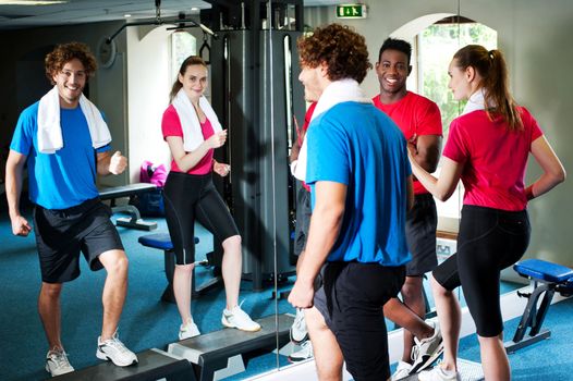 Young couple working out in front of their trainer