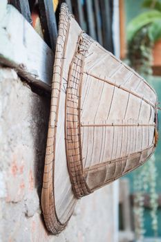 Old handmade hat hanging on vintage wall