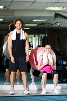 Sporty young couple posing for an image, indoor shot