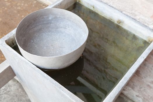 Old style thai used water bowl floating on water