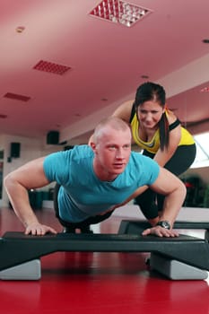Young caucasian couple working out at fitness club