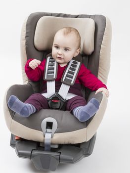 booster seat with child for a car in light background. studio shot.