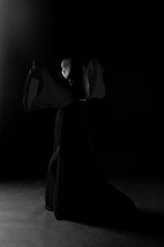 Young girl dancer in a darkness befor start
