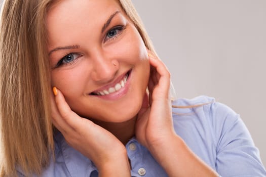 Closeup portrait of young blond caucasian woman smiling