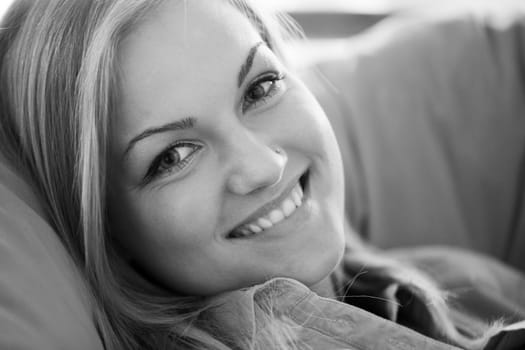 B&W portrait of young blond caucasian woman smiling