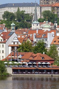 czech republic, prague - hradcany castle and riverside restaurant at mala strana