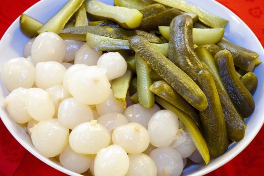a plate of pearl onions and pickles