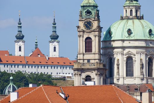 prague - st. nicolas clock tower and spires of strahov monastery at mala strana