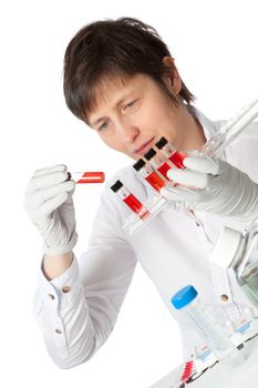 Isolated scientist woman in lab coat with liquid samples.