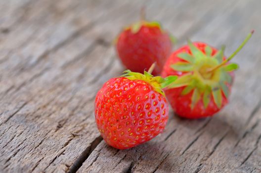 Fresh strawberries on old wooden background