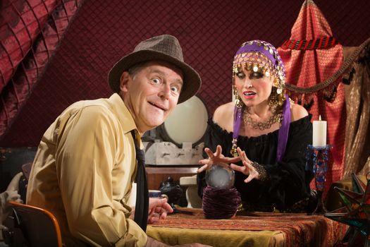 Smiling businessman getting his fortune from pretty gypsy woman