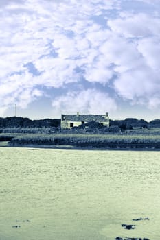 an old abandoned Irish rustic cottage on a river Shannon estuary in county Kerry