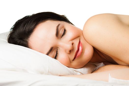 Portrait of a beautiful young woman sleeping peacefully. Isolated over white.