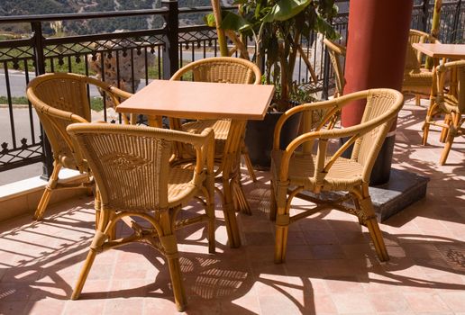 Cafe with wicker chairs on the balcony-style palace of Knossos. Crit. Greece.