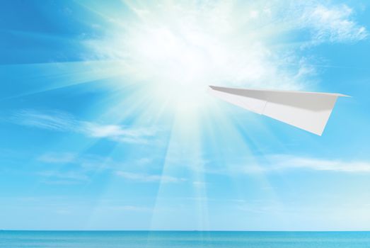 paper plane against beautiful blue Caribbean sky, sea and sun