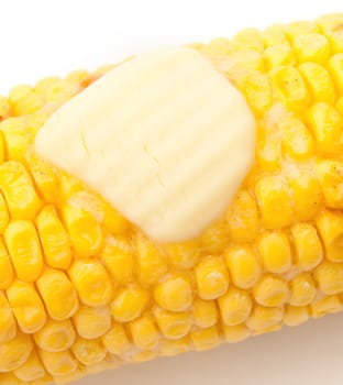 Closeup of butter melting on cooked corn on the cob