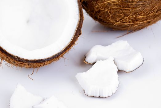 freshly cut coconut and milk isolated on white background