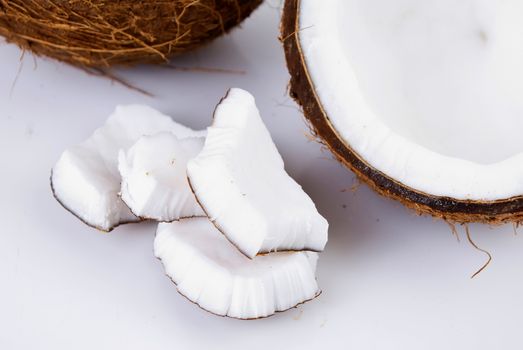 freshly cut coconut and milk isolated on white background