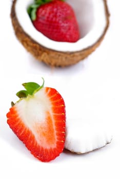 healthy fresh fruits - strawberries and coconut isolated on white background