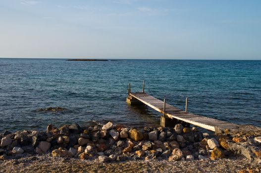 Wooden pier by the sea .