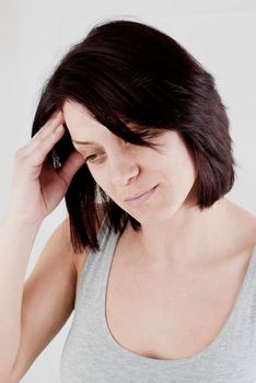 young woman with headache making massage to avoid pain