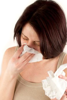 sneezing woman holding tissues, allergy or cold flu concept