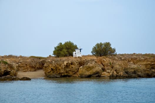 Small orthodox chapel by the sea on island of Crete .