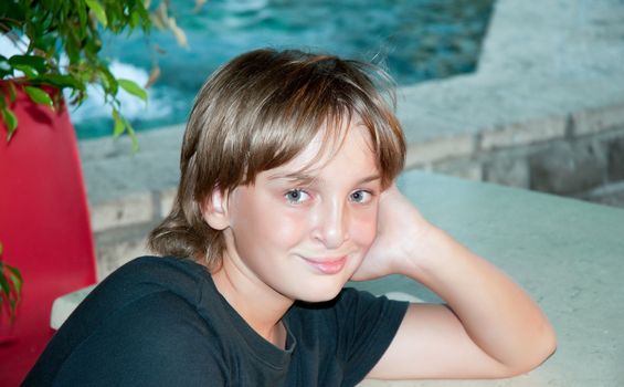 Portrait of a smiling young boy outside .