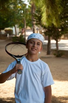 Young boy with tennis racket .