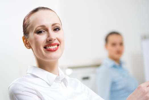 portrait of a business woman in office, smiling and looking into the camera, office work