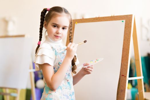 portrait of a girl standing next to his easel, a drawing lesson