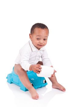 Child on potty play with toilet paper, isolated over white