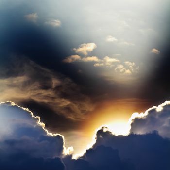 View of clouds in blue sky with rays of light