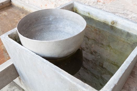 Old style thai used water bowl floating on water