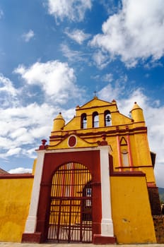Yellow colonial church with beautiful blue sky in San Cristobal de las Casas in Chiapas, Mexico