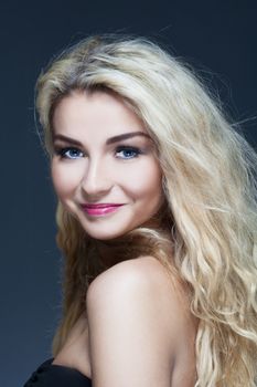 portrait of a young beautiful woman with long blond hair smiling