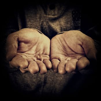 High contrast image of a person begging