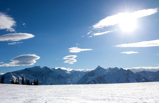 winter with ski slopes of kaprun resort next to kitzsteinhorn peak in austrian alps