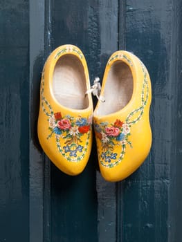Dutch wooden shoes hanging on a wooden wall
