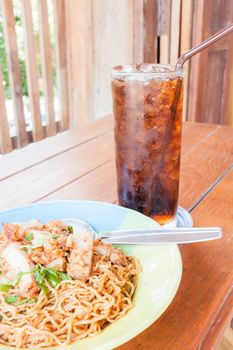 Simple meal with stir fried spicy noodles and cola