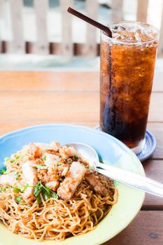Fast meal with stir fried spicy noodles and cola